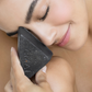 Woman with activated charcoal facial exfoliating soap anti impurities anti acne