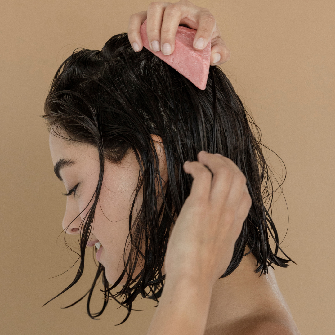 Woman using shampoo bar for dry hair